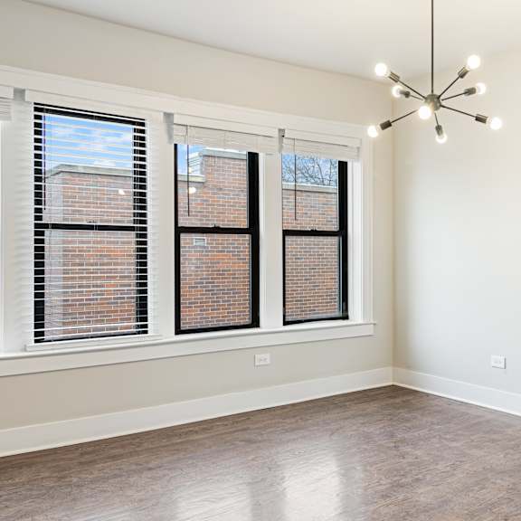 a room with a large window and a chandelier.