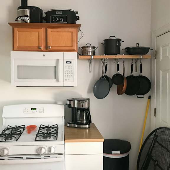a kitchen with a white stove, a microwave, and a coffee maker.