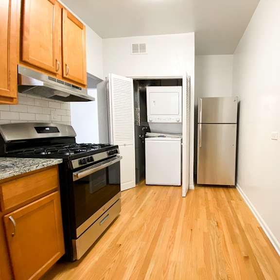 a kitchen with wooden cabinets and a black stove top oven.