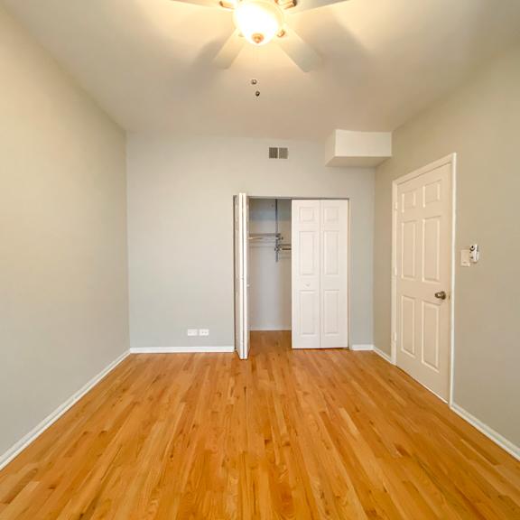 a room with wooden floors and white walls.