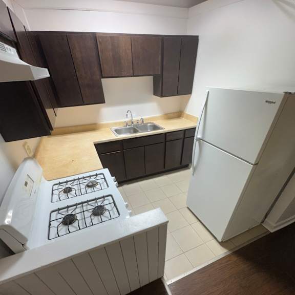 a white stove top oven with a black back splash.