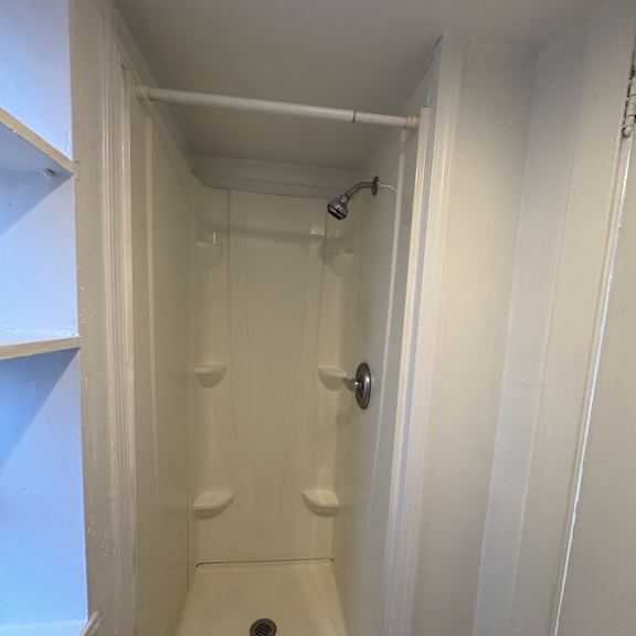 a white ceiling with a light fixture and a white door.