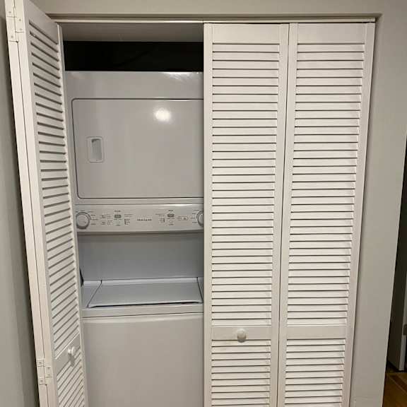a microwave oven is placed on a shelf.