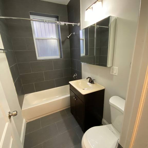 a bathroom with a shower and a window.