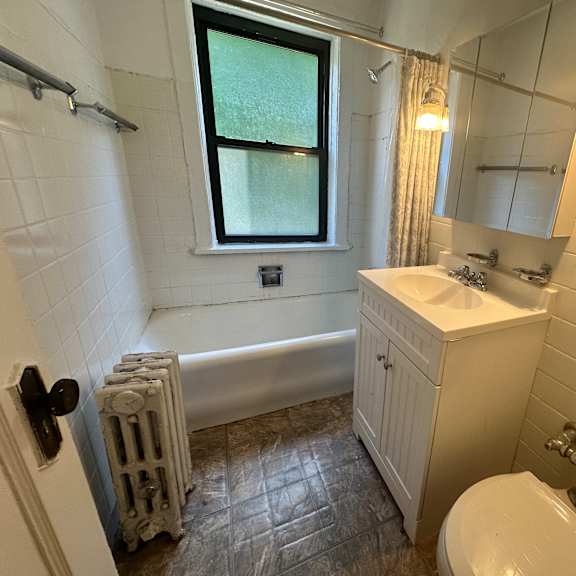 a bathroom with a sink toilet and a tub