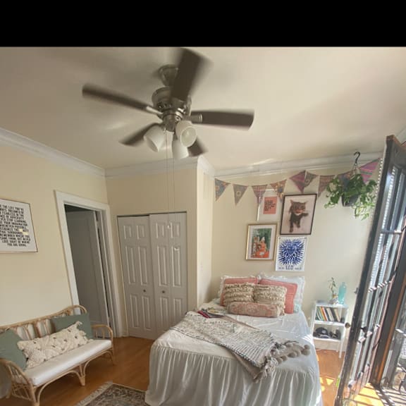 a bedroom with a bed and a ceiling fan