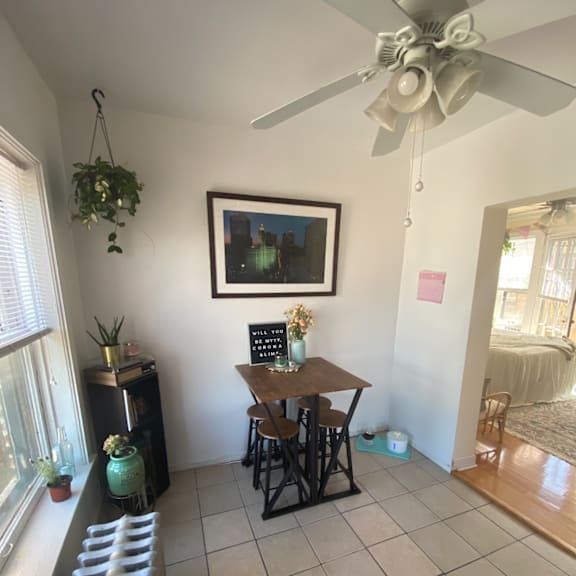 a dining room with a table and a ceiling fan