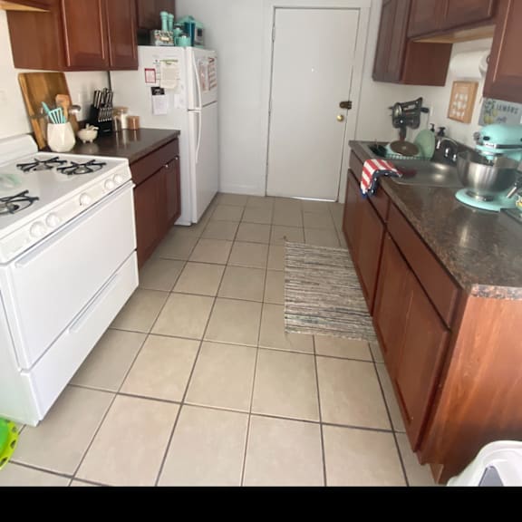 a kitchen with a stove refrigerator and a sink