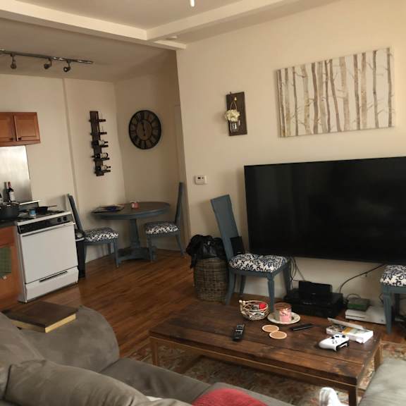 a living room with a grey couch and a wooden coffee table.