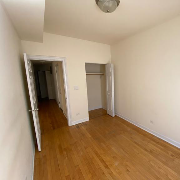 a room with wooden floors and white walls.
