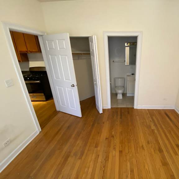 a kitchen with a white door open to a hallway.