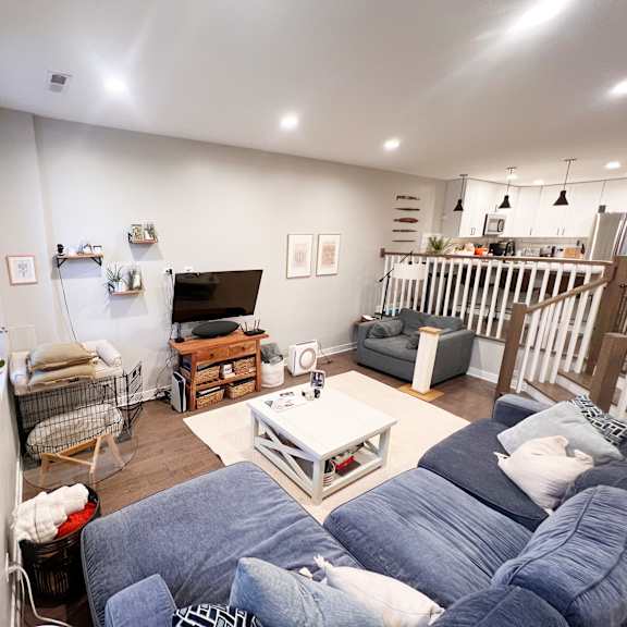 a living room with a grey sofa and a white coffee table.