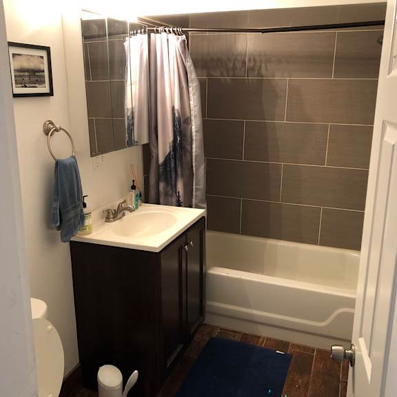 a bathroom with a sink, toilet and shower.