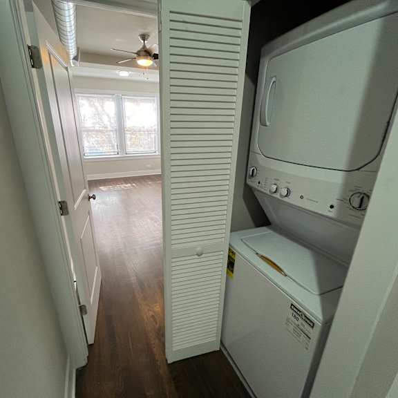 a white dryer is sitting in a small room.