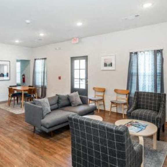a living room with a couch and chairs and a table