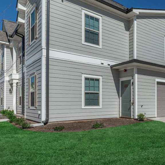a white house with a driveway and a garage door