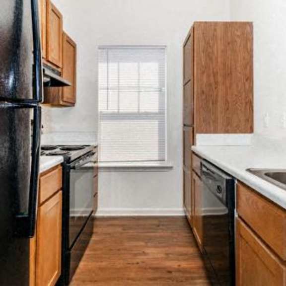 a kitchen with a sink and a stove and a refrigerator