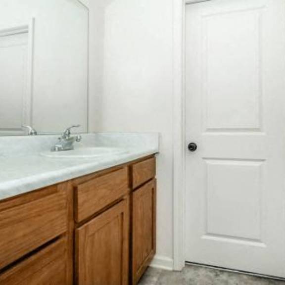 a bathroom with a sink and a white door