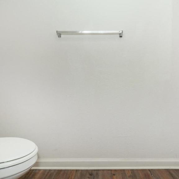a white bathroom with a toilet and a sink