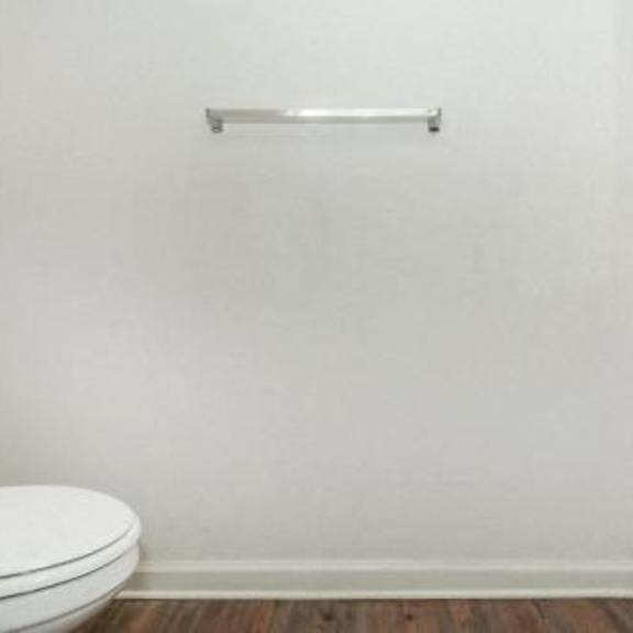 a white bathroom with a toilet and a sink