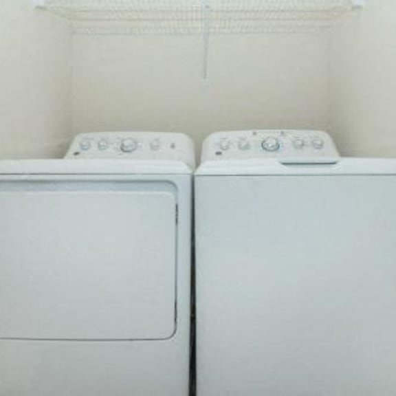 a white washer and dryer in a white room