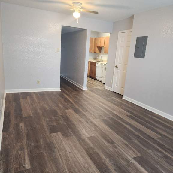 a room with wooden flooring and a ceiling fan.