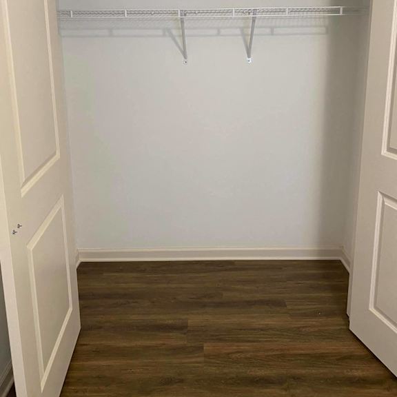 a room with a white wall and a wood floor