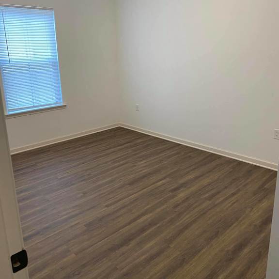 a view from the top of a staircase with wood flooring