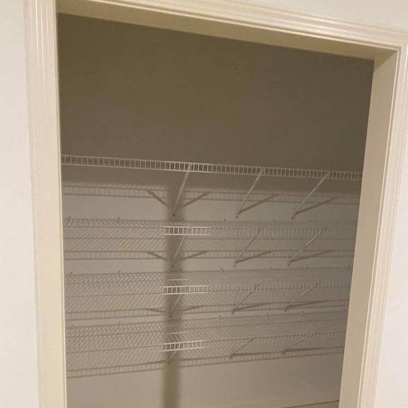the inside of an empty closet with a mirrored closet door