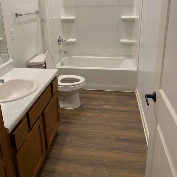 a bathroom with a shower toilet and sink
