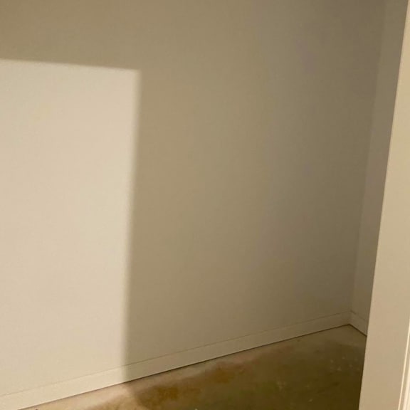 the corner of a room with white walls and a door