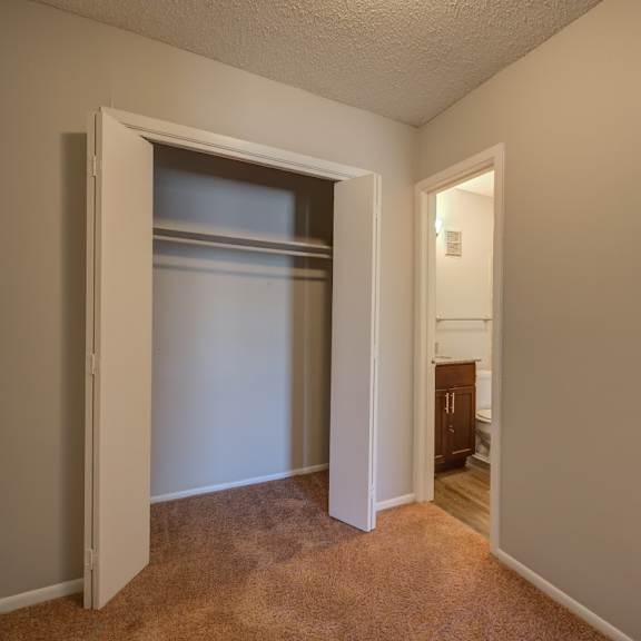 a room with a carpeted floor and a white door.