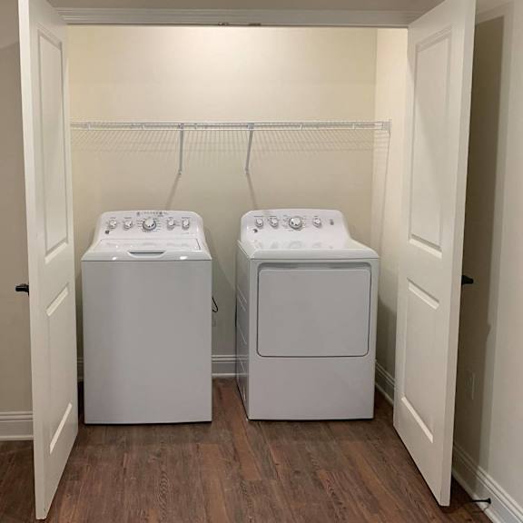 a washer and dryer in a room with white doors