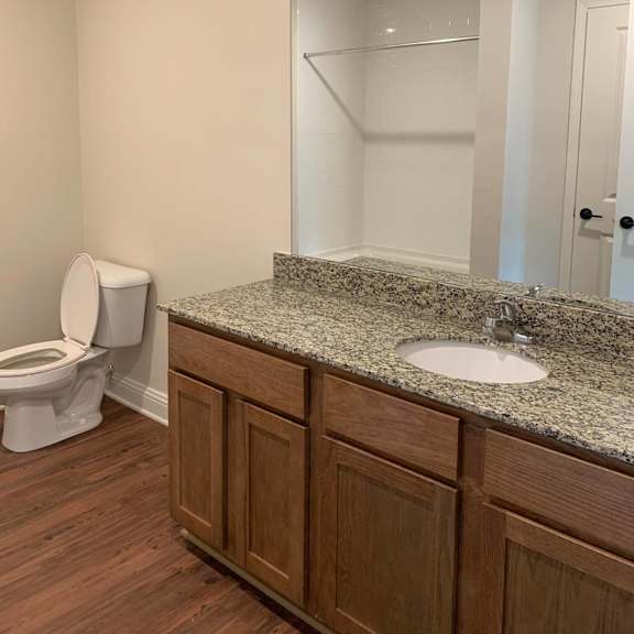 a bathroom with a sink toilet and a mirror