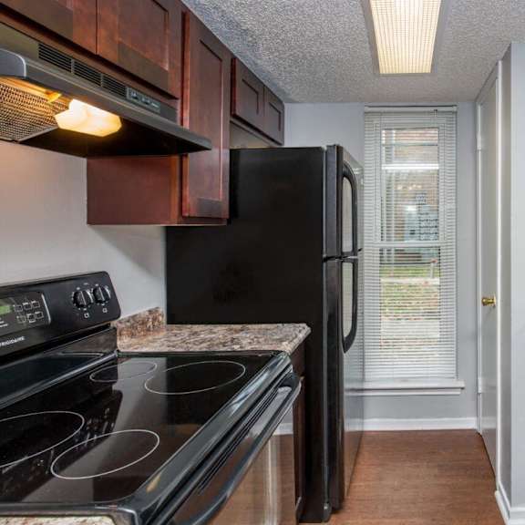 a kitchen with black appliances and granite counter tops