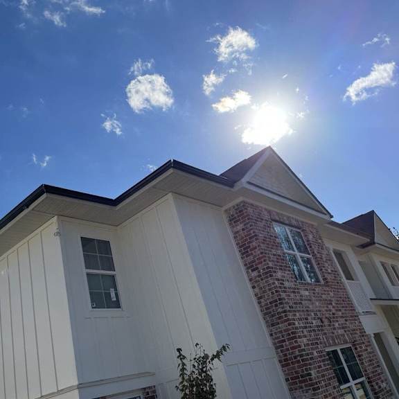 the exterior of a house with the sun shining in the sky