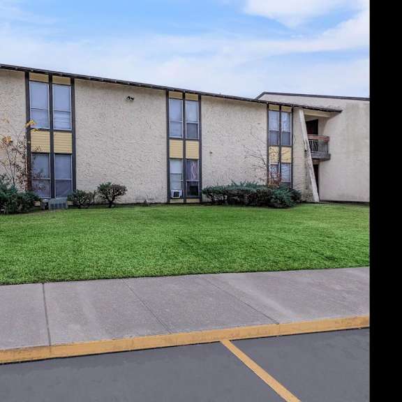 a building with a parking lot in front of it.