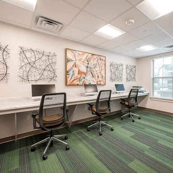 a room with a green carpet and a painting on the wall.