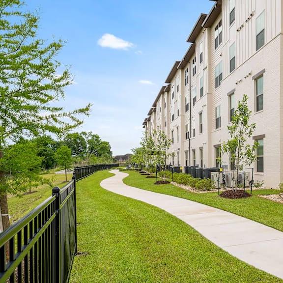 a long building with a green lawn in front.