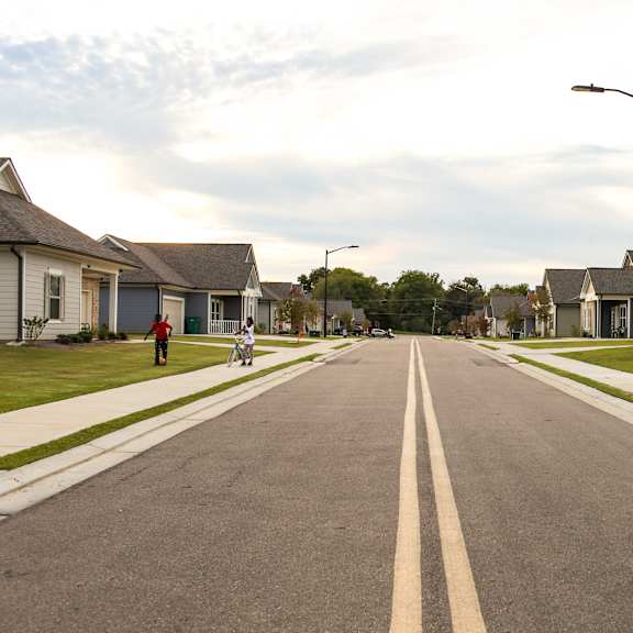 an empty street with houses on both sides of it