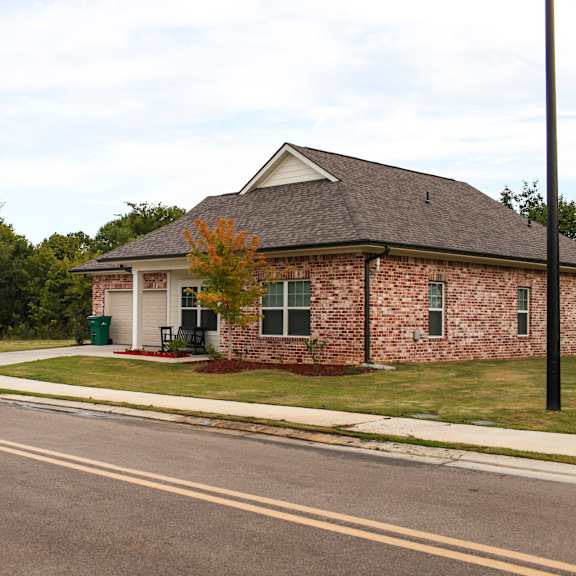 a small brick house on the side of the road