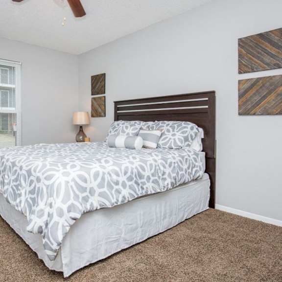 a bedroom with two beds and two windows