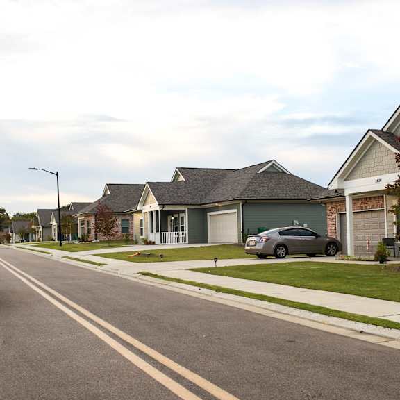 a car parked on the side of a street in front of houses