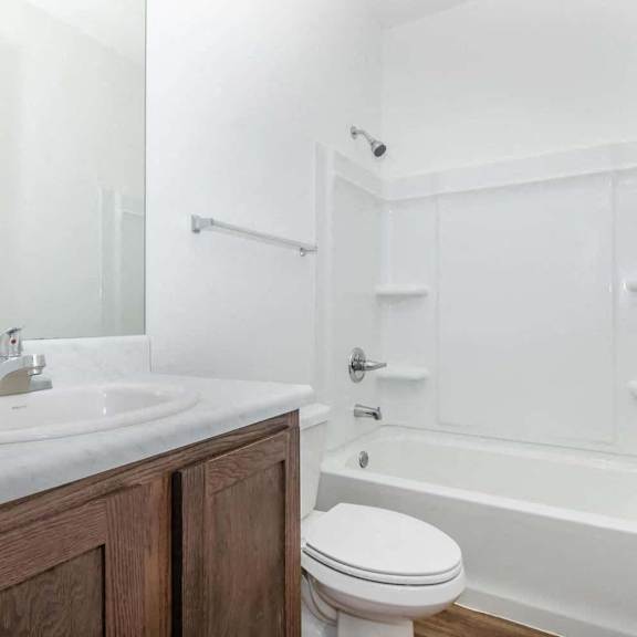 a bathroom with a sink toilet and a bath tub