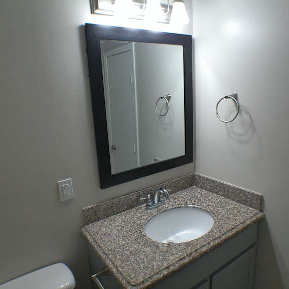 a small bathroom with a sink and a mirror