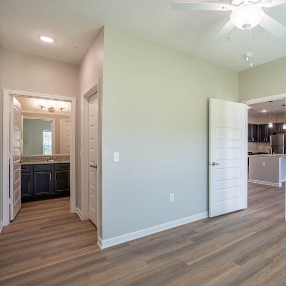 a room with a ceiling fan and lighting fixtures.