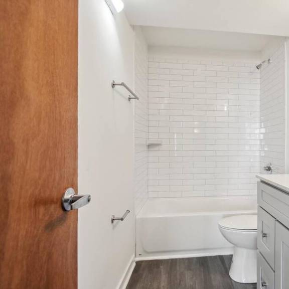 a white sink is on a countertop next to a white toilet.