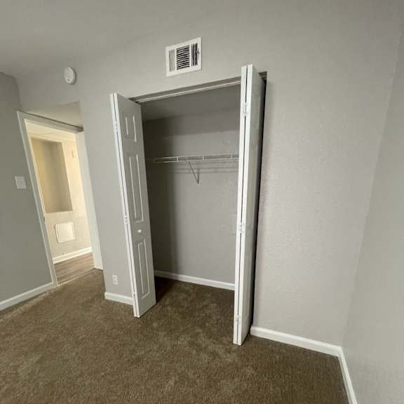 a room with a closet and a doorway.