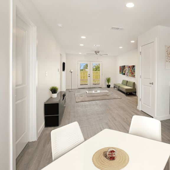 a modern kitchen with a dining table set for two.