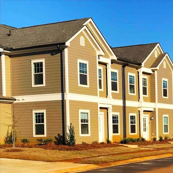 a row of town houses on the side of a street